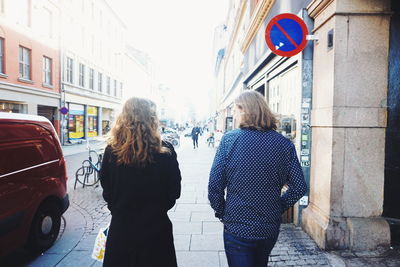 Rear view of couple standing in city