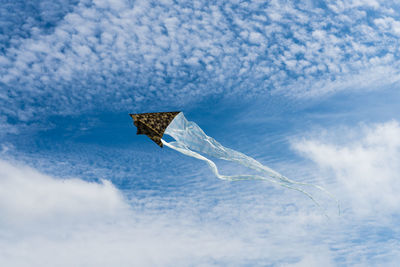 Low angle view of helicopter flying in sky