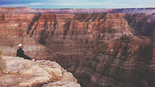 Man sitting on cliff at grand canyon national park