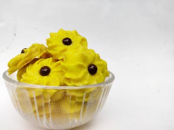 Close-up of lemon in bowl against white background