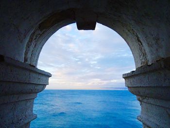 Scenic view of sea seen through arch 