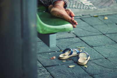 Low section of woman standing on street