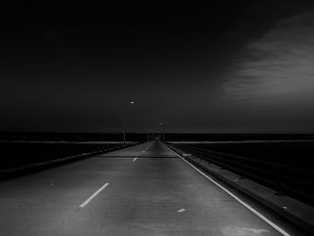 Country road against sky at night