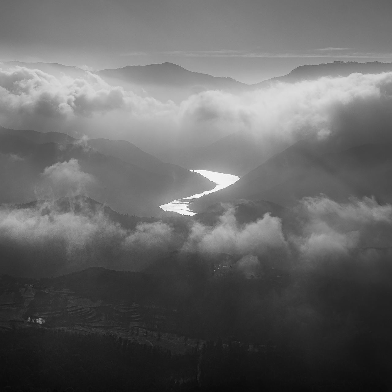 cloud, black and white, environment, darkness, monochrome, mountain, fog, sky, monochrome photography, landscape, scenics - nature, beauty in nature, nature, mist, no people, horizon, mountain range, travel, outdoors, land, tranquility, cloudscape, sunlight, dramatic sky, white, travel destinations, tranquil scene, aerial view, sunbeam, atmospheric mood, light, day