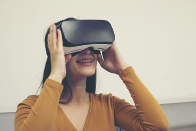 Young woman wearing virtual reality simulator