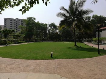 Scenic view of golf course against clear sky