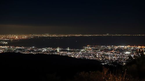 High angle view of illuminated buildings against sky at night