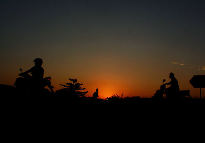 Silhouette of woman at sunset