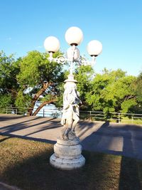 Statue in park against sky