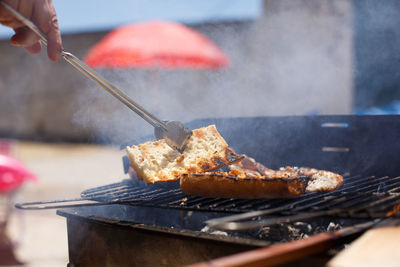 Toasted bread on homemade barbecue, outside on a sunny day.