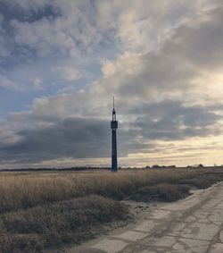 Tower on field against sky