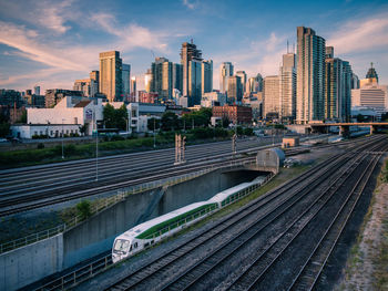 High angle view of train on tracks against buildings