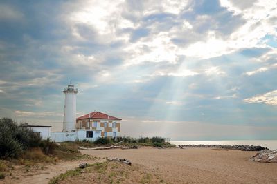 Scenic view of beach by sea against sky