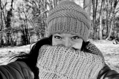 Close-up portrait of woman wearing warm clothing in park during winter