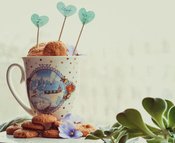 Close-up of cookies in mug on table