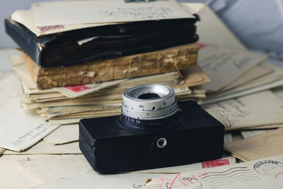 Close-up of camera and old books on table