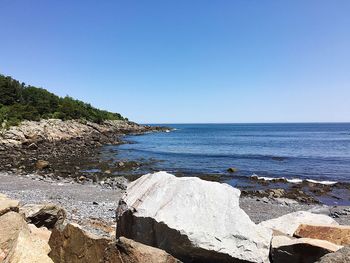 Scenic view of sea against clear blue sky