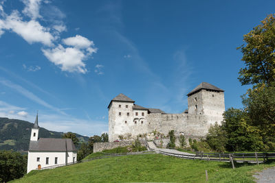 Low angle view of old building against blue sky