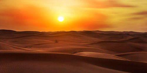 Scenic view of desert against sky during sunset