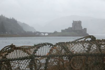 Scenic view of river and mountains against sky