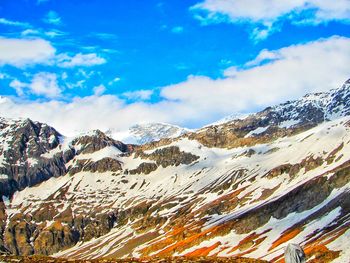 Scenic view of snow covered mountains against sky