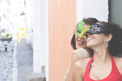 Portrait of two women wearing venice carnival mask. 