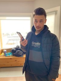 Portrait of young man using mobile phone