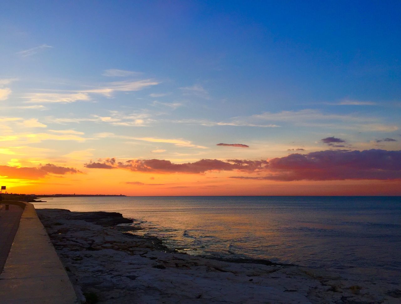 SCENIC VIEW OF SEA AGAINST ORANGE SKY