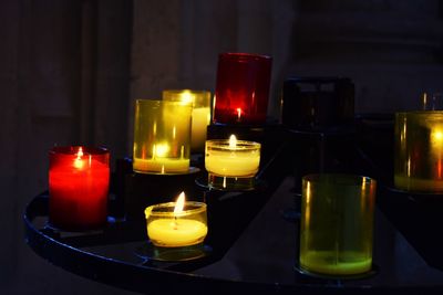 Close-up of lit tea light candles on table