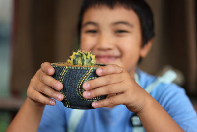 Close-up portrait of boy holding food