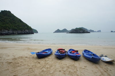 Boats on beach against sky