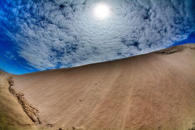 Scenic view of desert against blue sky