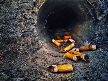 High angle view of cigarette burning on fire