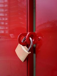 Close-up of padlock on red door
