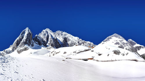 One traveler enjoys the snow in sunny day on jade dragon snow mountain of yunnan kunming, china