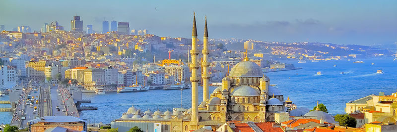 Panoramic view of illuminated buildings in city against sky