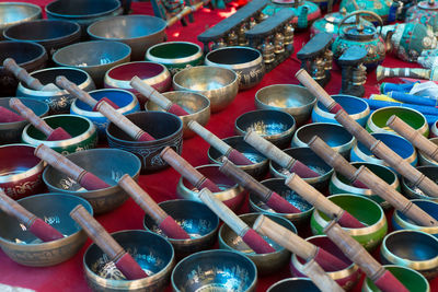 High angle view of singing bowls arranged on table for sale in store