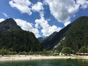 Scenic view of mountains by lake against sky