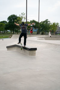 Full length of man skateboarding on skateboard against sky