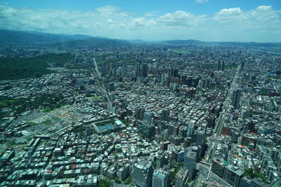 High angle view of modern buildings in city against sky