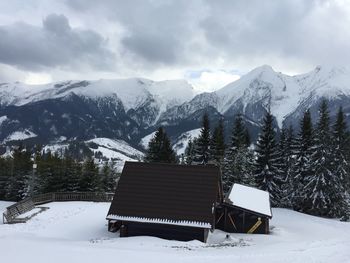 Scenic view of snow covered mountains against sky