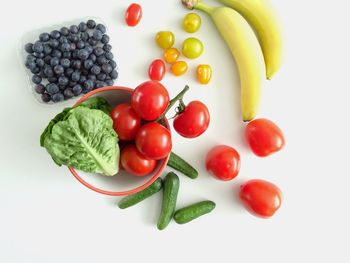 Fruits in plate against white background