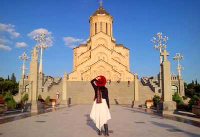 Female visitor being impressed by holy trinity cathedral of tbilisi or the sameba, tbilisi, georgia