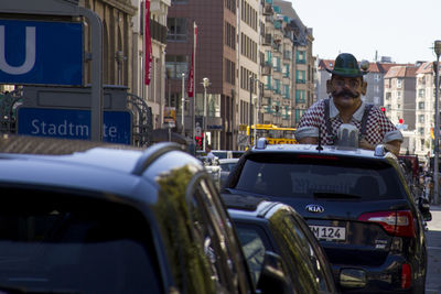 Man in car on city street