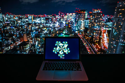 Illuminated modern buildings in city at night