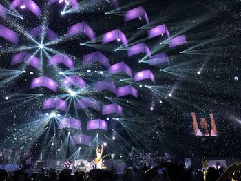 Low angle view of firework display at night