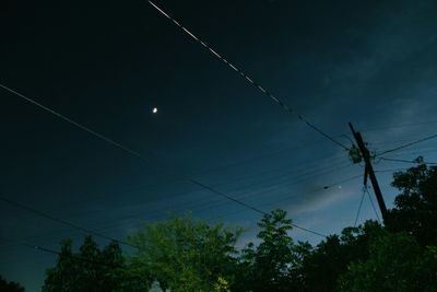 Low angle view of power lines against sky