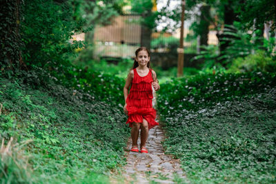 Portrait of smiling girl standing on grass