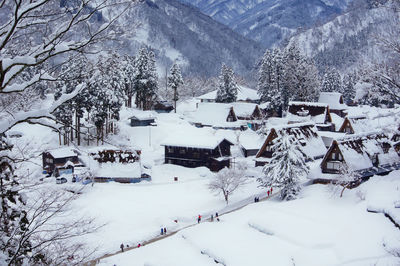 Scenic view of snow covered landscape and houses