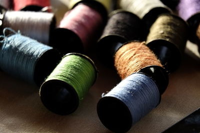 Close-up of colorful spools of thread on fabric